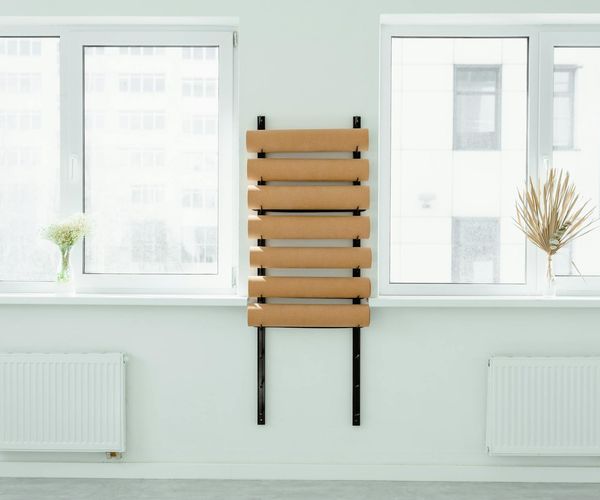 Bright and spacious studio with yoga mats and large windows.