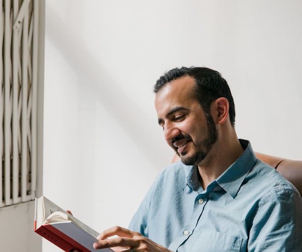Smiling person in a comfortable pose, enjoying a moment of calm.